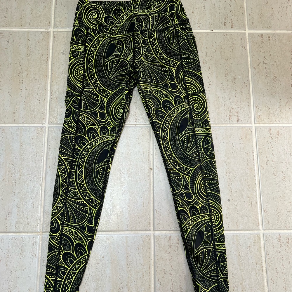 CVG black leggings with neon green pattern.